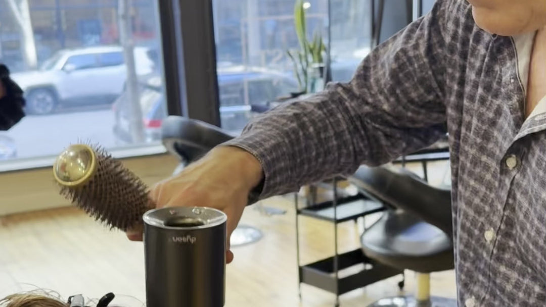 Stylist creating a blowout with a round brush at 3rd Coast Salon Chicago